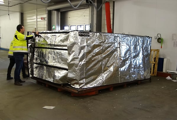 Foil cover being wrapped around aircraft pallet