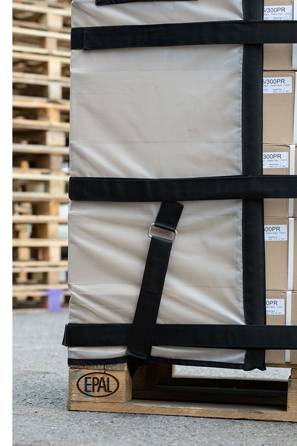 A close-up image showing the Cargowrap corner strap securing it to the pallet